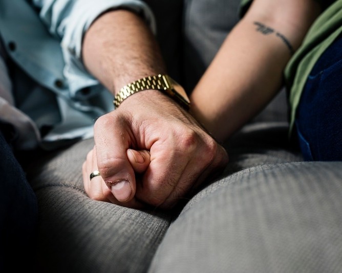 Couple holding hands representing relationship counseling and emotional support services through an employee assistance program