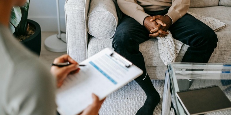 Employee speaking with a counselor during a workplace Employee Assistance Program (EAP) counseling session for mental health and personal support.